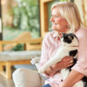 senior woman holding a cat smiling