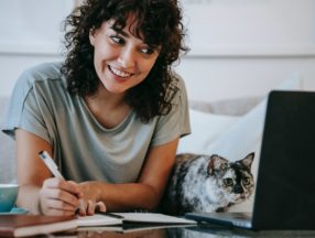 woman and cat using computer