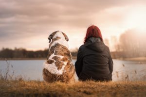 Woman and her dog on the lake