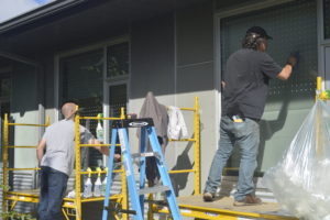 two men installing bird safe windows