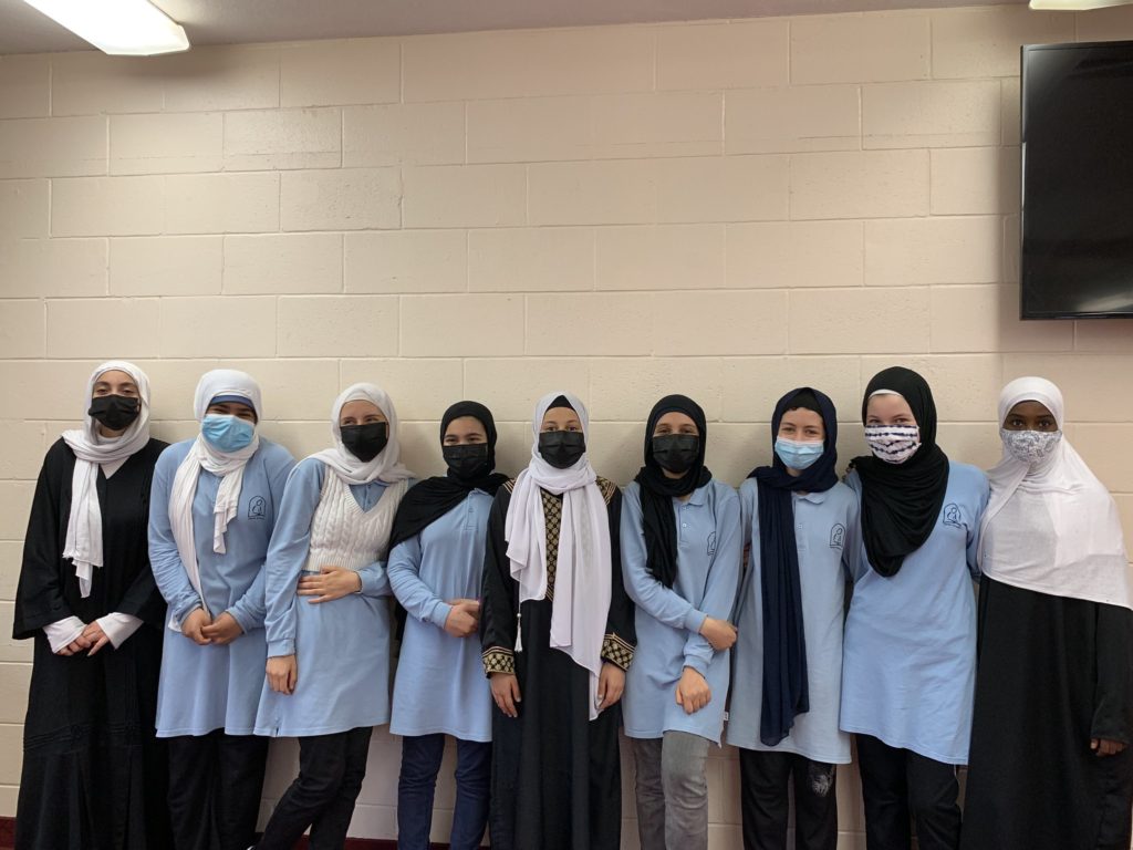 several young students standing in a line
