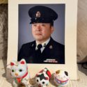 A portrait of James Ito with maneki-neko (beckoning cat) a Japanese figurine which is believed to bring good luck to the owner.